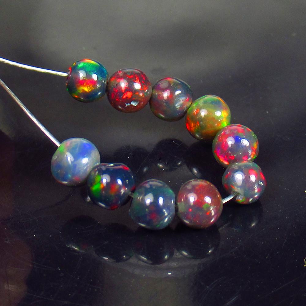 3.10 Ctw Natural 10 Drilled Black Fire Opal Ball Beads: No Reserve! Title: 3.10 Ctw Natural 10 Drilled Black Fire Opal Ball Beads Stone Clarity: Transparent Gemstones: Black Opal Beads Carat Weights: 3.1 Size/Dimensions: 3.70 - 4.20 mm / 10 Pcs Additional 