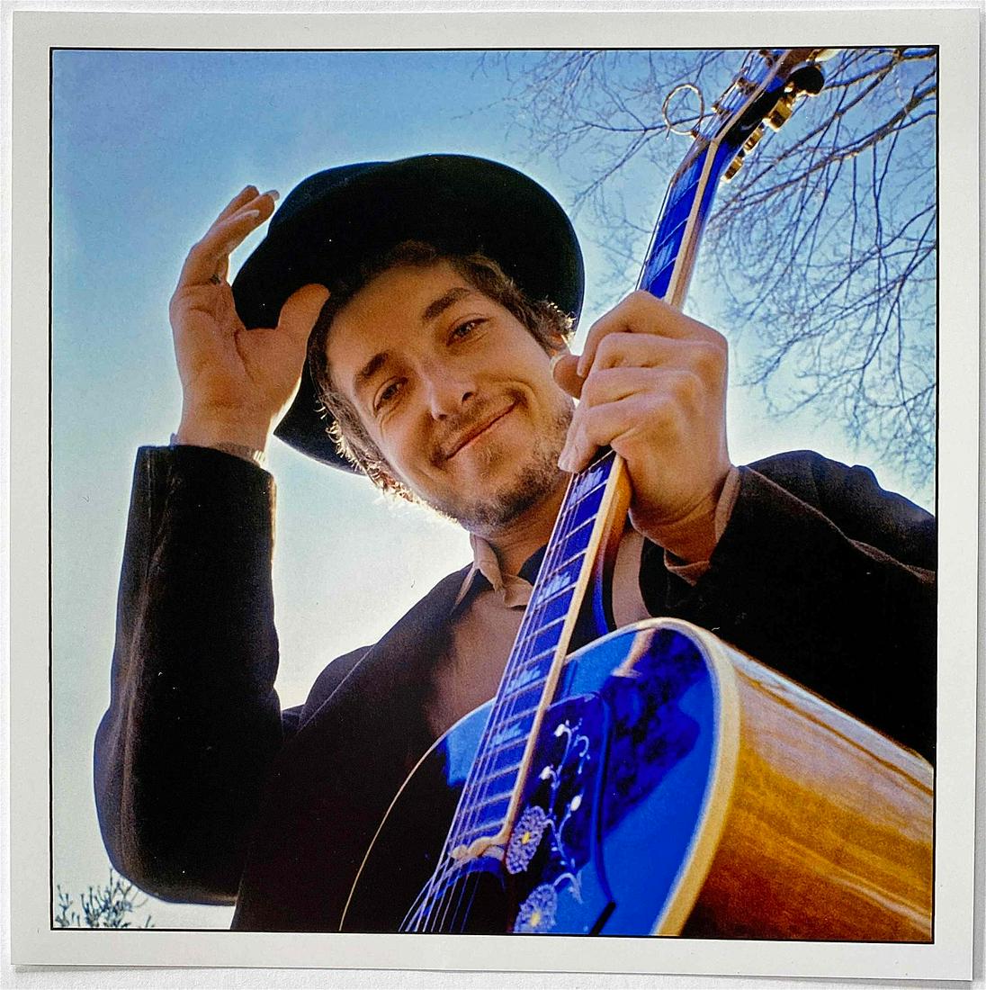 Elliot Landy- Bob Dylan: Woodstock NY 1969: Color photograph signed in pen verso 6" x 6" sheet Reserve: $220.00 Shipping: Domestic: Flat-rate of $20.00 to anywhere within the contiguous U.S. International: Foreign shipping rates are determined