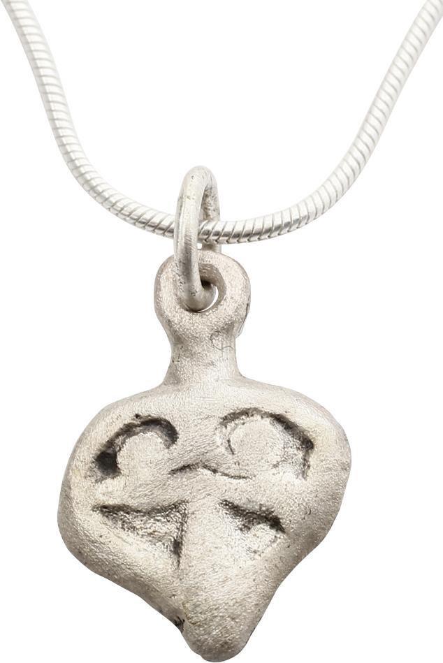 FINE VIKING HEART NECKLACE PENDANT 900-1050 AD: Just under 3/4 “ height, made by the open face mold method with high relief decoration. Heart form with broad borders and a trefoil in the field. The form of the heart is stylized with the top c