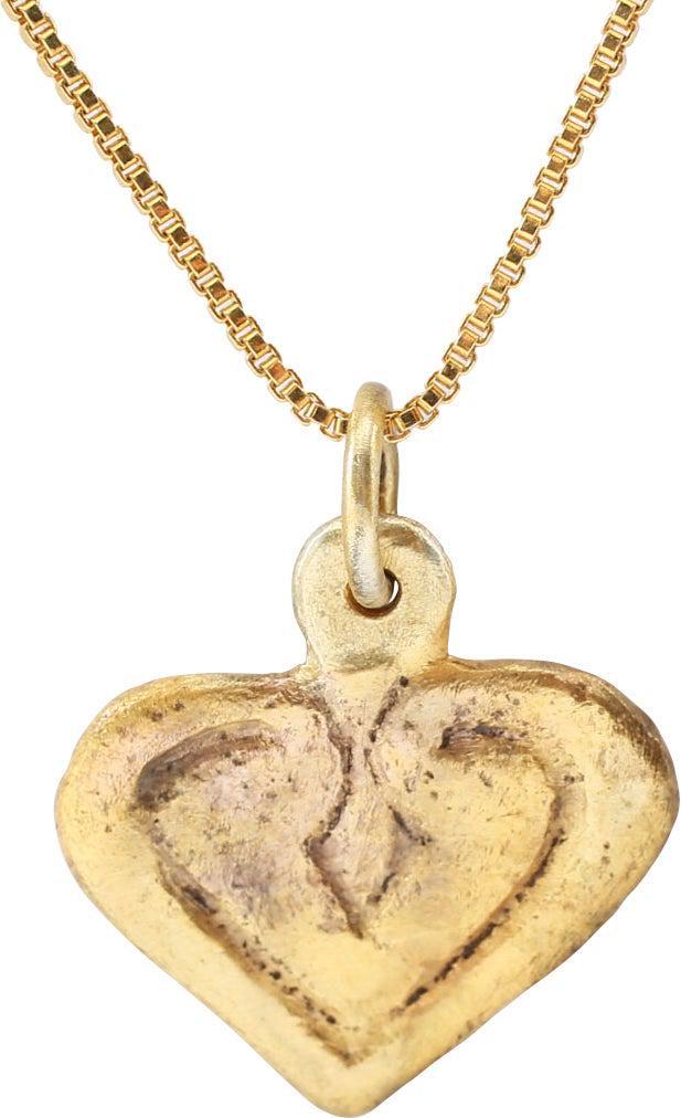 FINE VIKING HEART PENDANT, 10TH-11TH CENTURY AD: Just under 3/4" width. Broad heart with broad borders forming the top cusp and extending into the field surrounding a diamond. A heart within a heart! Made by the open face mold technique. The heart s