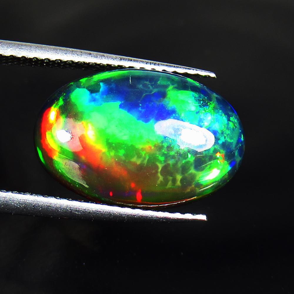 4.97 Ctw Natural Black Fire Opal Oval Cabochon: Title: 4.97 Ctw Natural Black Fire Opal Oval Cabochon Stone Clarity: Opaque Gemstone: Natural Opal Carat Weight: 4.97 Size/Dimensions: 16.10 x 10.60 x 5.60 mm Additional Information: Shape - Oval Cabo