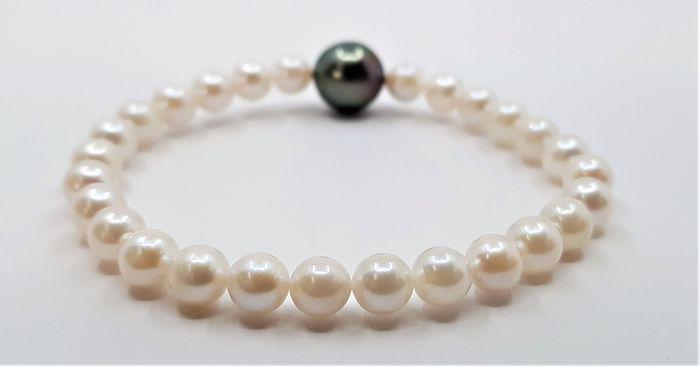 Bright 6x11.5mm Tahiti - Akoya pearls - Bracelet: Title: Bright 6x11.5mm Tahiti - Akoya pearls - Bracelet Description: A beautiful pearl bracelet of white saltwater Akoya pearls with one stunning Tahitian pearl. The classic Akoya pearl is a type of c