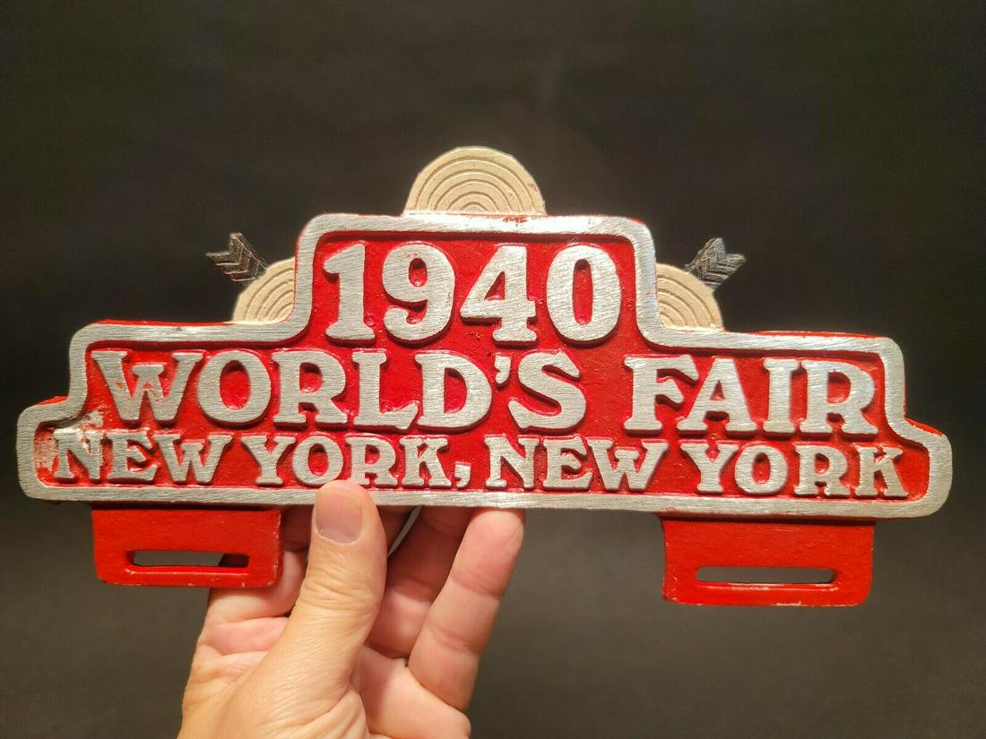 1940 World's Fair New York License Plate Frame Topper: 10 1/2"Wide x 5" High Such a neat accurate reproduction aluminum license plate frame. This frame is all solid metal, hand painted. I checked it with a magnet it doesn't attract. Reserve: $25.00 Shippi