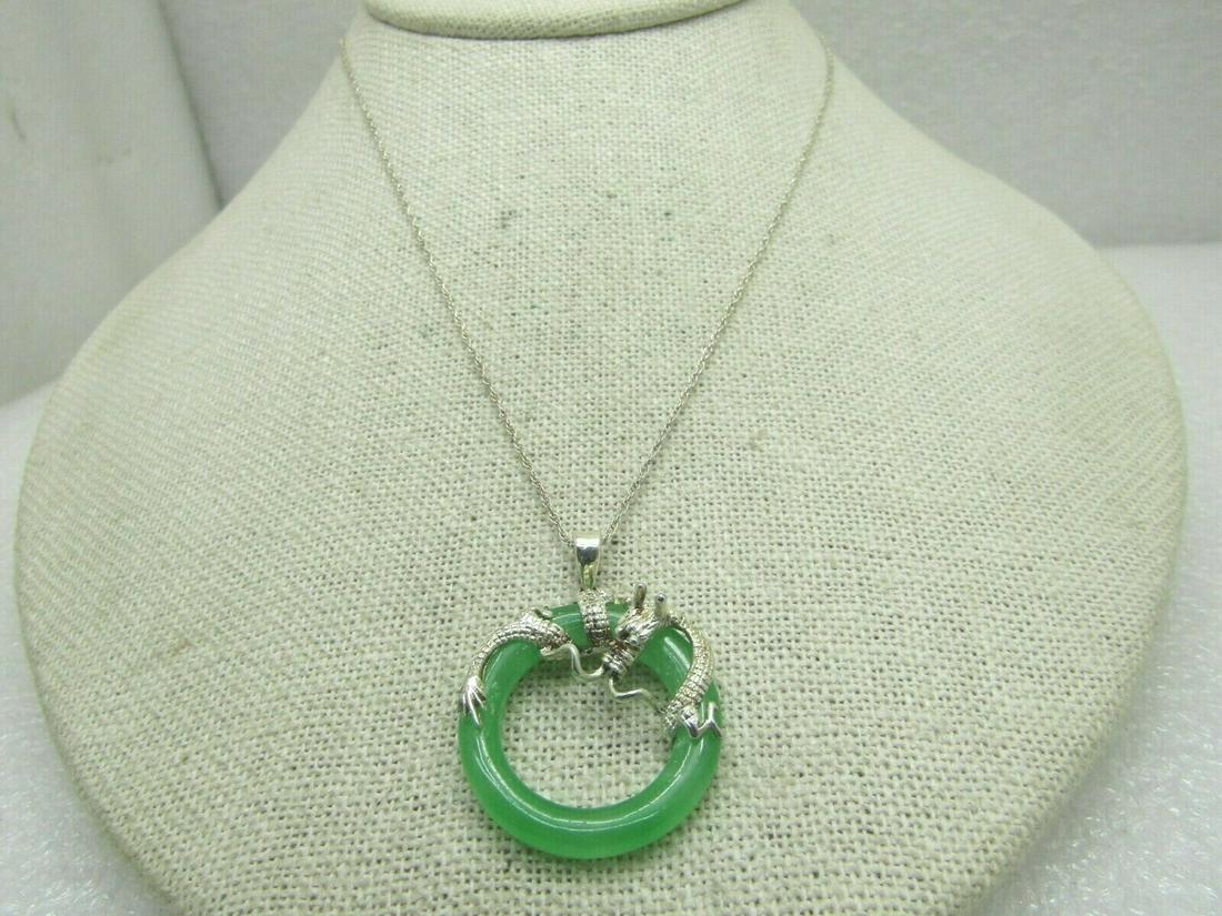 Sterling Silver Jadeite Dragon Necklace, 16", 5.49 Gr., Signed N/C: Sterling Silver Jadeite Dragon Necklace, 16", jadeite green hoop that is 1-3/8" long with bail and 1" wide with a dragon wrapped around the top of the hoop. The dragon and chain test as sterling. It i