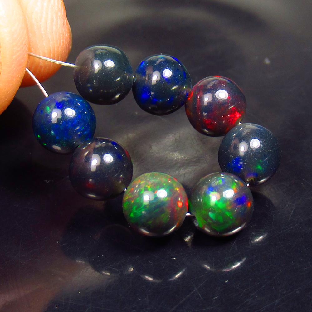 8.14 Ctw Natural 8 Drilled Black Fire Opal Ball Beads: No Reserve! Title: 8.14 Ctw Natural 8 Drilled Black Fire Opal Ball Beads Stone Clarity: Transparent Gemstones: Black Opal Beads Carat Weights: 8.14 Size/Dimensions: 6.10 - 6.20 mm / 8 Pcs Additional I