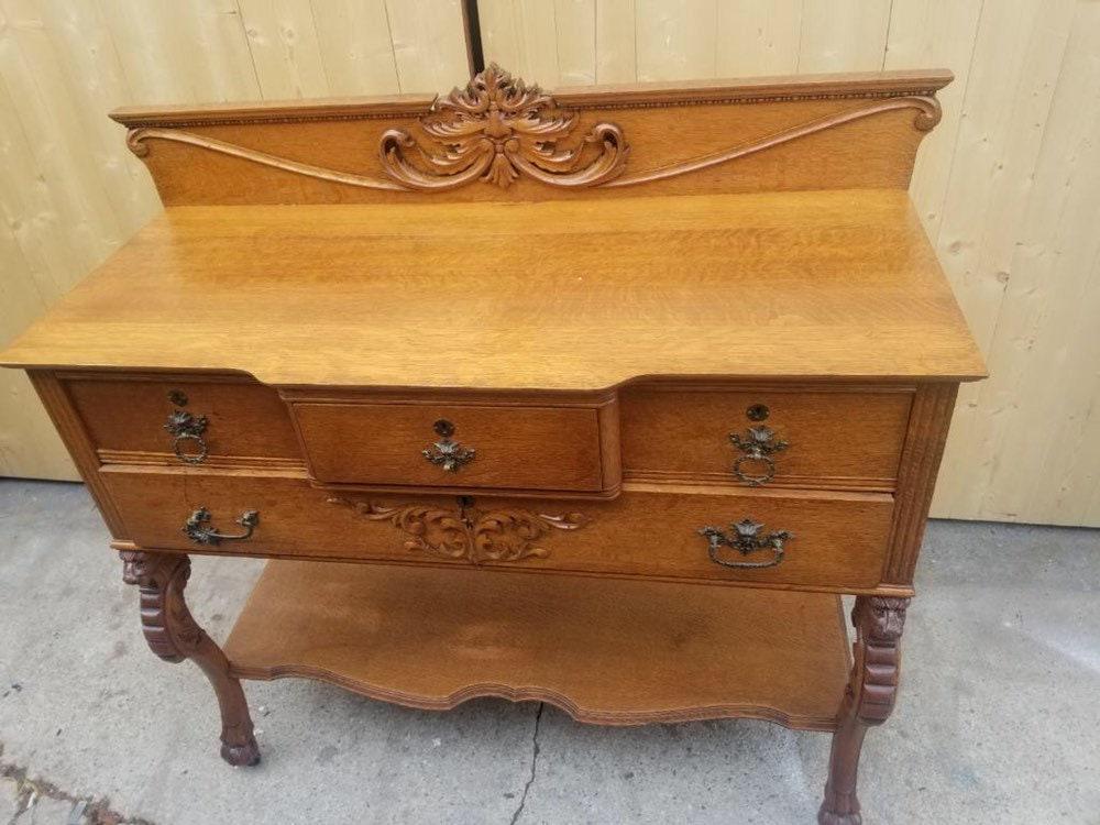 Antique Carved Figural Lion Head and North Wind Face Hall Chest Commode Dresser: Vintage from the 19th century Materials: oak, wood Description Antique Carved Figural Lion Head and Northwind Face Hall Chest Commode Dresser This early Craftsman period small chest/commode is solid f