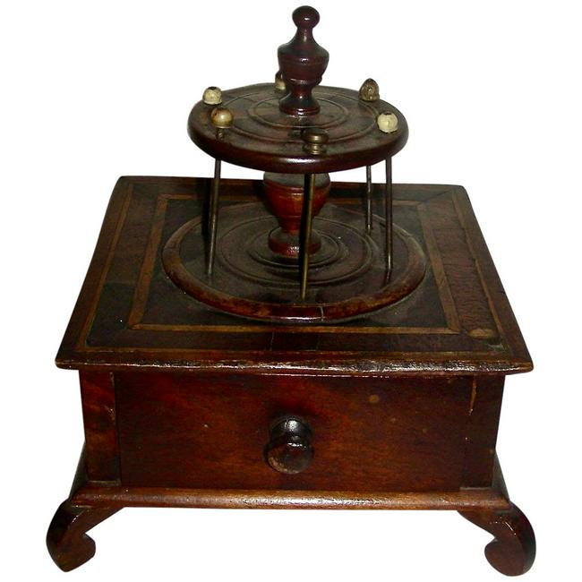 Inlaid Sewing Spool Box w/Drawer: A very graphic 19th century Inlaid Mahogany 1-Drawer Sewing Box. There is a round spool holder incorporated into the top and curved legs Overall height is 8 1/2" and the box (including the splayed leg