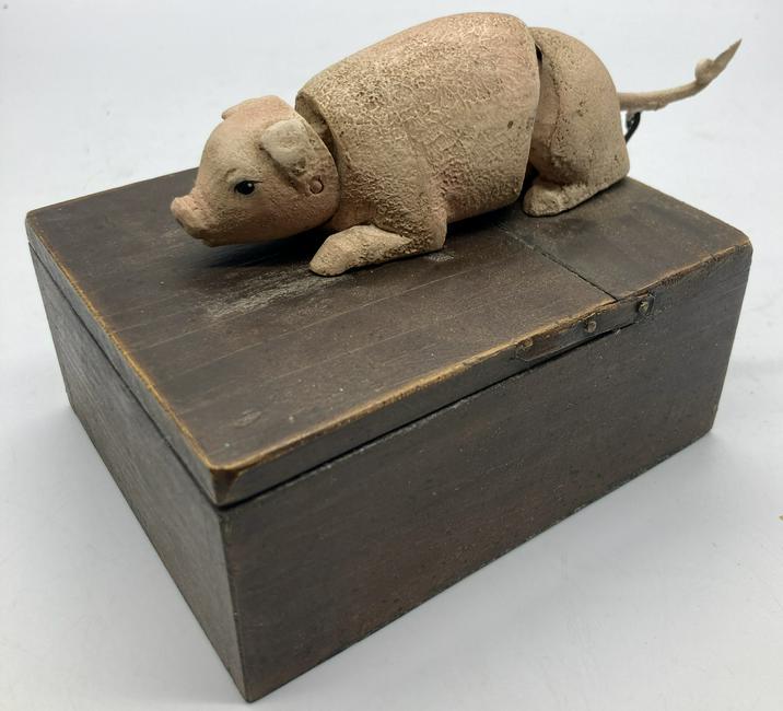 Rare COMPOSITE PAPER MACHE MECHANICAL PIG BOX BANK: Title: Rare COMPOSITE PAPER MACHE MECHANICAL PIG BOX BANK Date/Period: approx early 1900's Dimension: wood box is 5" long x 4" wide x 2 1/4" high. The pig is 6" nose to tail. Materials: MIXED MATERIAL