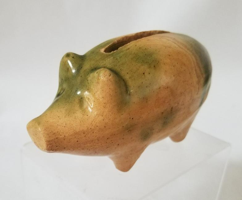 Yellowware pig bank, 2 color glaze.: Title: Yellowware pig bank, 2 color glaze. Provenance/additional info: 4 1/2" long. C. 1920s Shipping: Domestic: Flat-rate of $10.00 to anywhere within the contiguous U.S. International: Foreign shipp