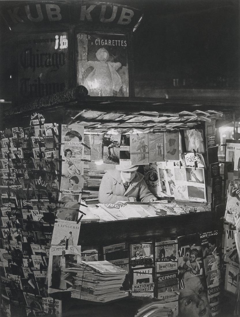 BRASSAI - Newsstand, Paris, 1930: Artist: Brassai Title: Newsstand, Paris, 1930 Medium: Photo Litho, 2008, China Dimesnions: 6.35x8.4" Description: Heat Wax Mounted on 8.5x11" Conservation Board Artist Bio: Brassai was a Hungarian-Fre