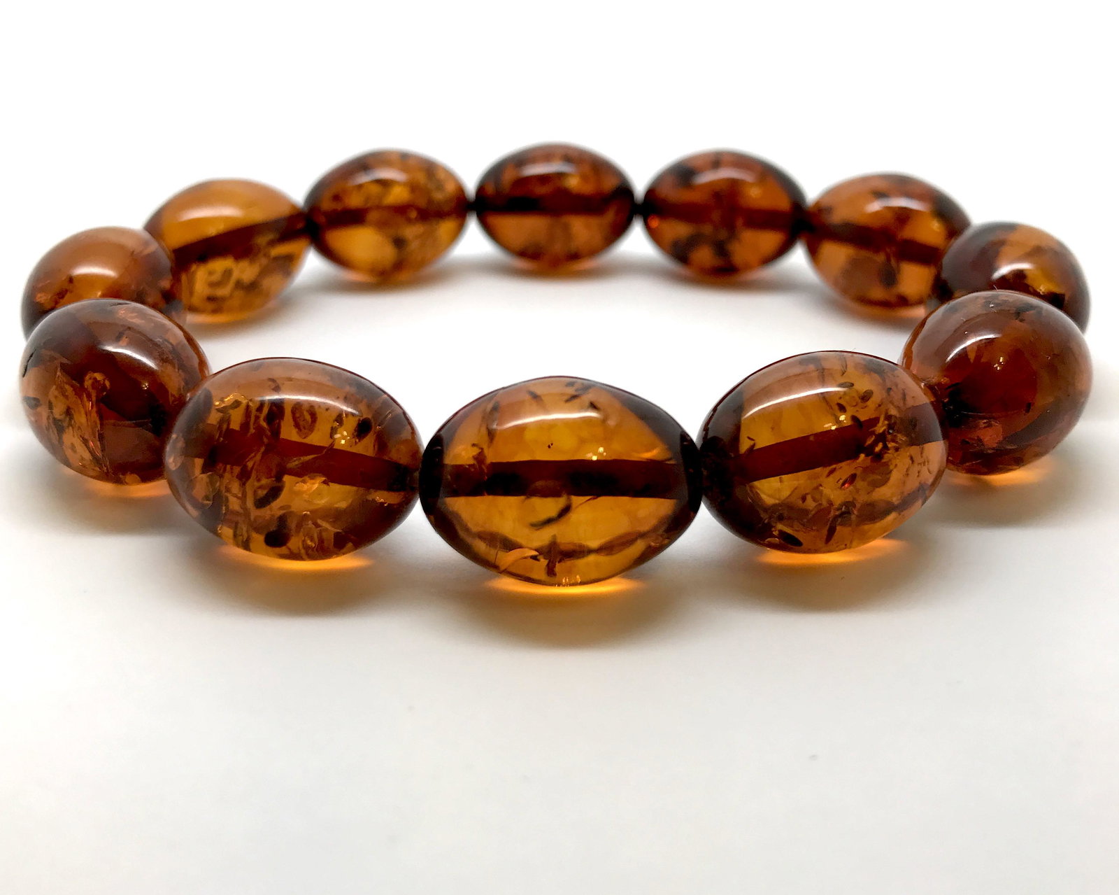 Astonishing Unique Vintage Amber Bracelet made from Olive shaped Amber beads: Title: Astonishing Unique Vintage Amber Bracelet made from Olive shaped Amber beads Metal: None Gemstones: Amber Weight: 17.0 g Size: Bead size: 16.9 x 12.2 mm Bead size: 0.665 x 0.48 inches Made of: