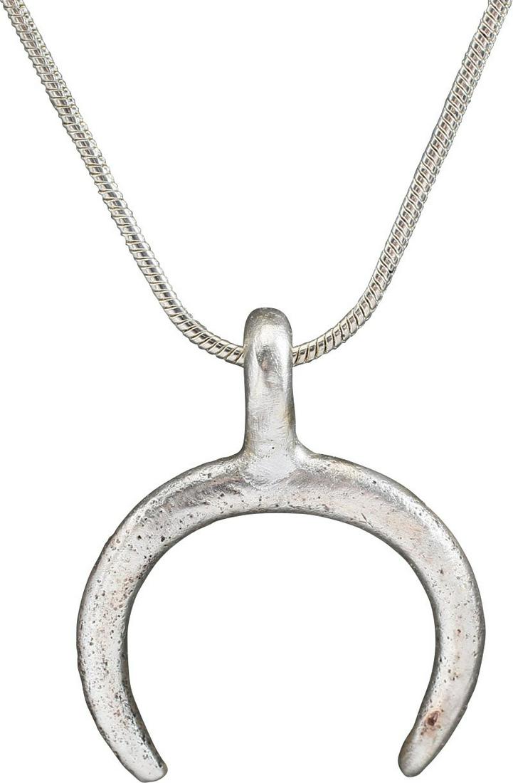ANCIENT VIKING LUNAR PENDANT, C.900-1000 AD: Over 1” (1.04) total height. Fine crescent form. As expert navigators, the constellations signified mystery and power to Vikings. The Moon was personified as Mani, brother to Sol the Sun, and is