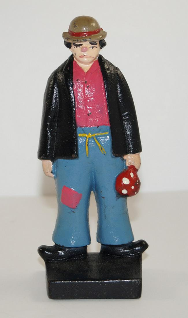 Antique Hobo Cast Iron Doorstop: Title: Antique Hobo Cast Iron Doorstop Provenance/Additional Info: Full-figure, solid casting Antique Doorstop depicting a Hobo just off the train. Dressed in patched pants tied with a string, wearing