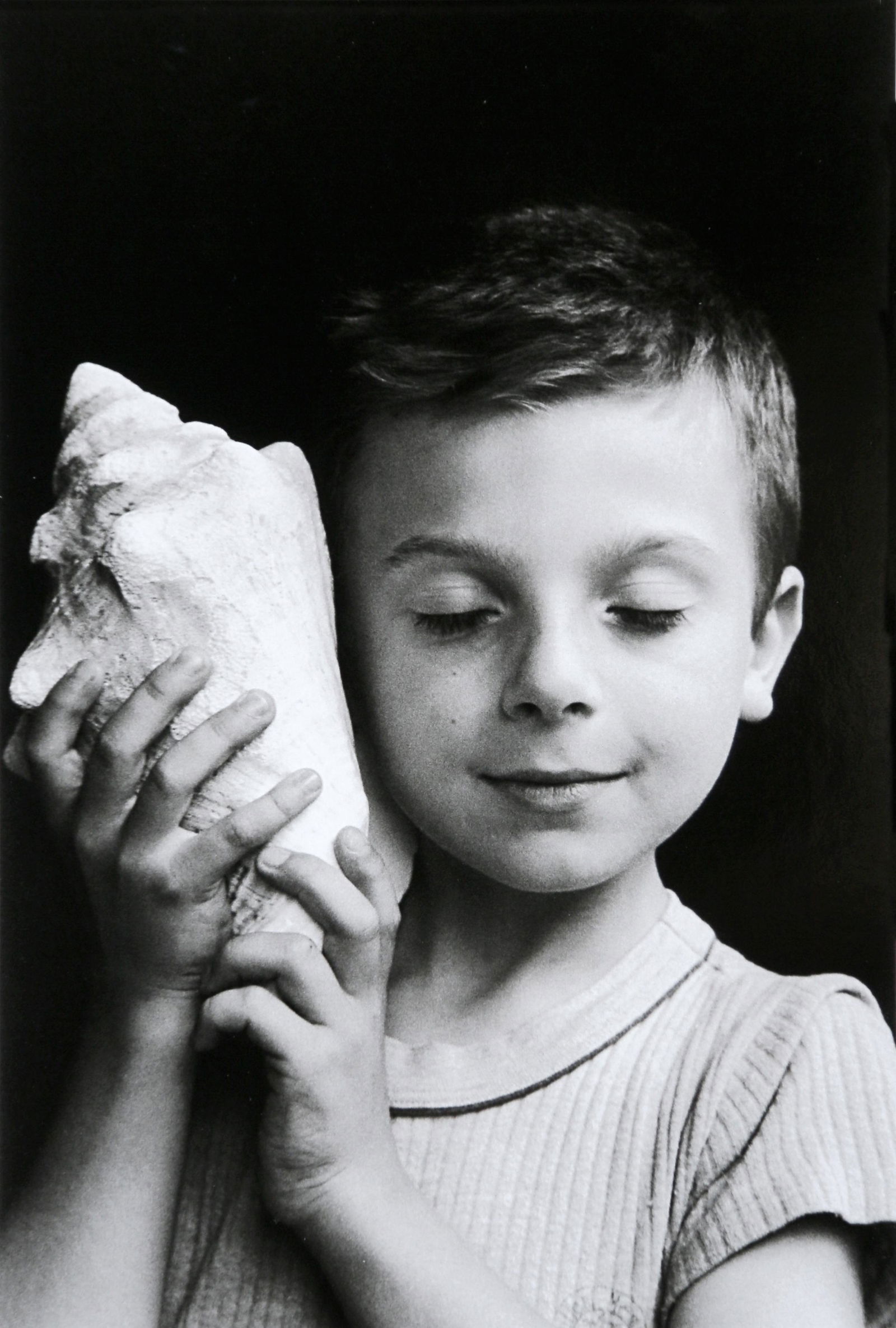 Edouard Boubat: Remy listening the sea, Paris: Artist: Edouard Boubat Title: Remy listening the sea, Paris Date: 2008 Medium: High Quality Photo Litho Print with Copyright Edouard Boubat/RAPHO/EYEDEA Print Origin: Printed in Italy - Portfolio Edit