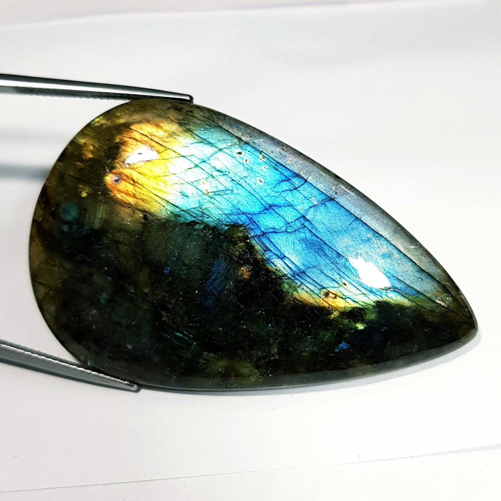 90.67 ct Natural Labradorite: No Reserve! Title: 90.67 ct Natural Labradorite Color/Clarity: Greenish Blue / Opaque Gemstone: Labradorite Carat Weight: 90.67 Size/Dimensions: 55.10 x 34.40 x 600 Additional Information: Pear / Afri