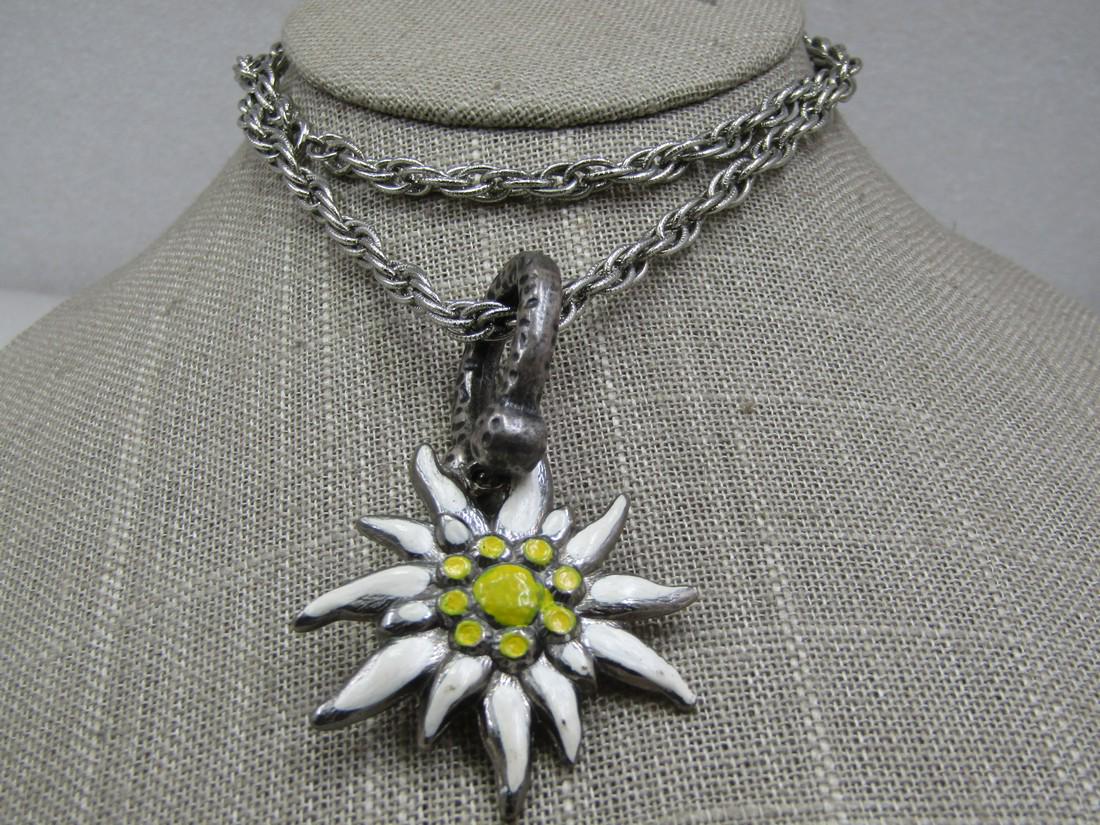 Vintage Enameled Edelweiss Hammered Necklace, 23": Vintage Enameled Edelweiss Hammered Necklace, 23" chain and 5mm wide textured and smooth silver tone multi-link rope chain. The bail is a chunky hammered bail with a w hite and yellow enameled edelwei