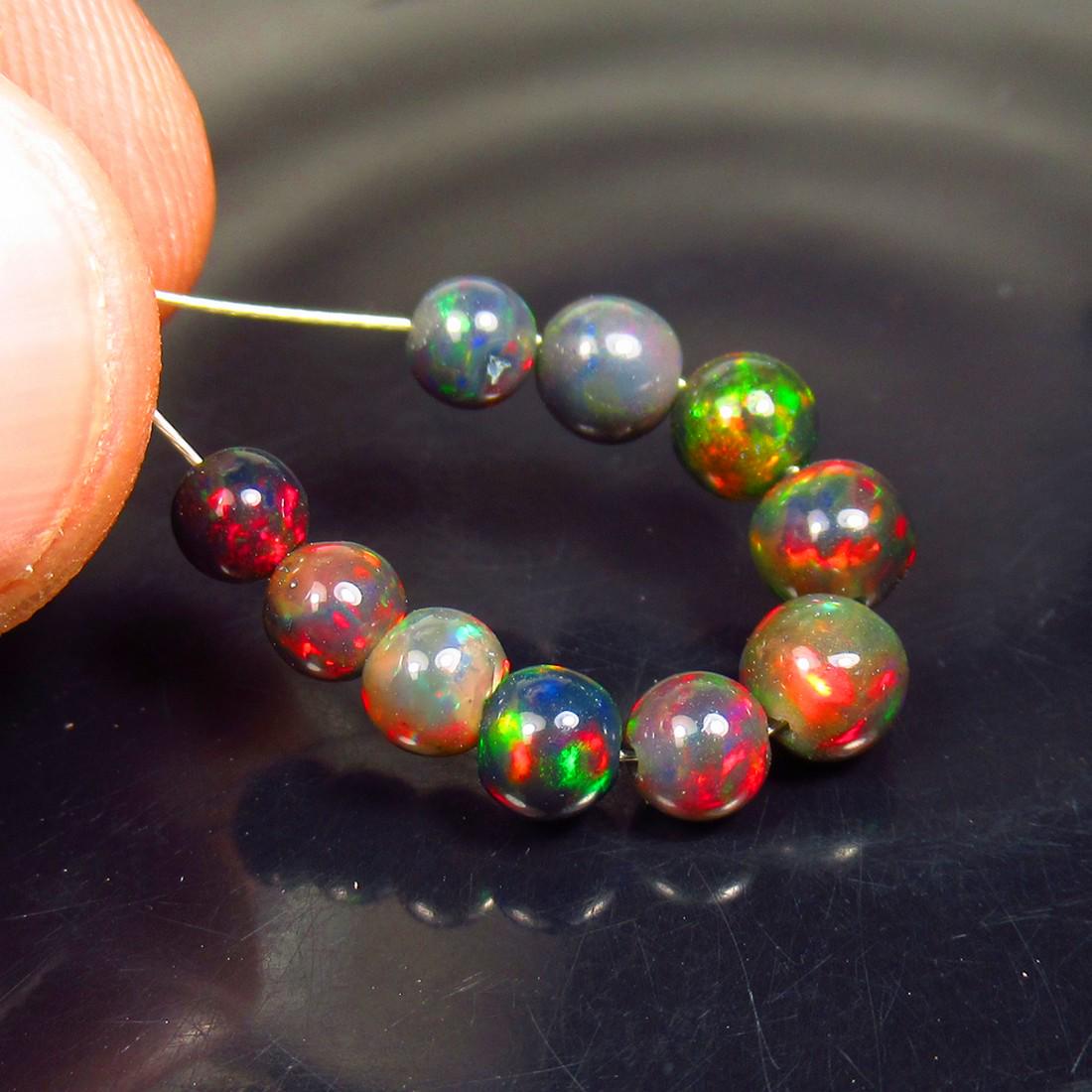 4.16 Ctw Natural 10 Drilled Black Fire Opal Ball Beads: No Reserve! Title: 4.16 Ctw Natural 10 Drilled Black Fire Opal Ball Beads Stone Clarity: Translucent Gemstone: Black Opal Beads Carat Weights: 4.16 Size/Dimensions: 4.10 to 5.00 mm / 10 PC's Additiona
