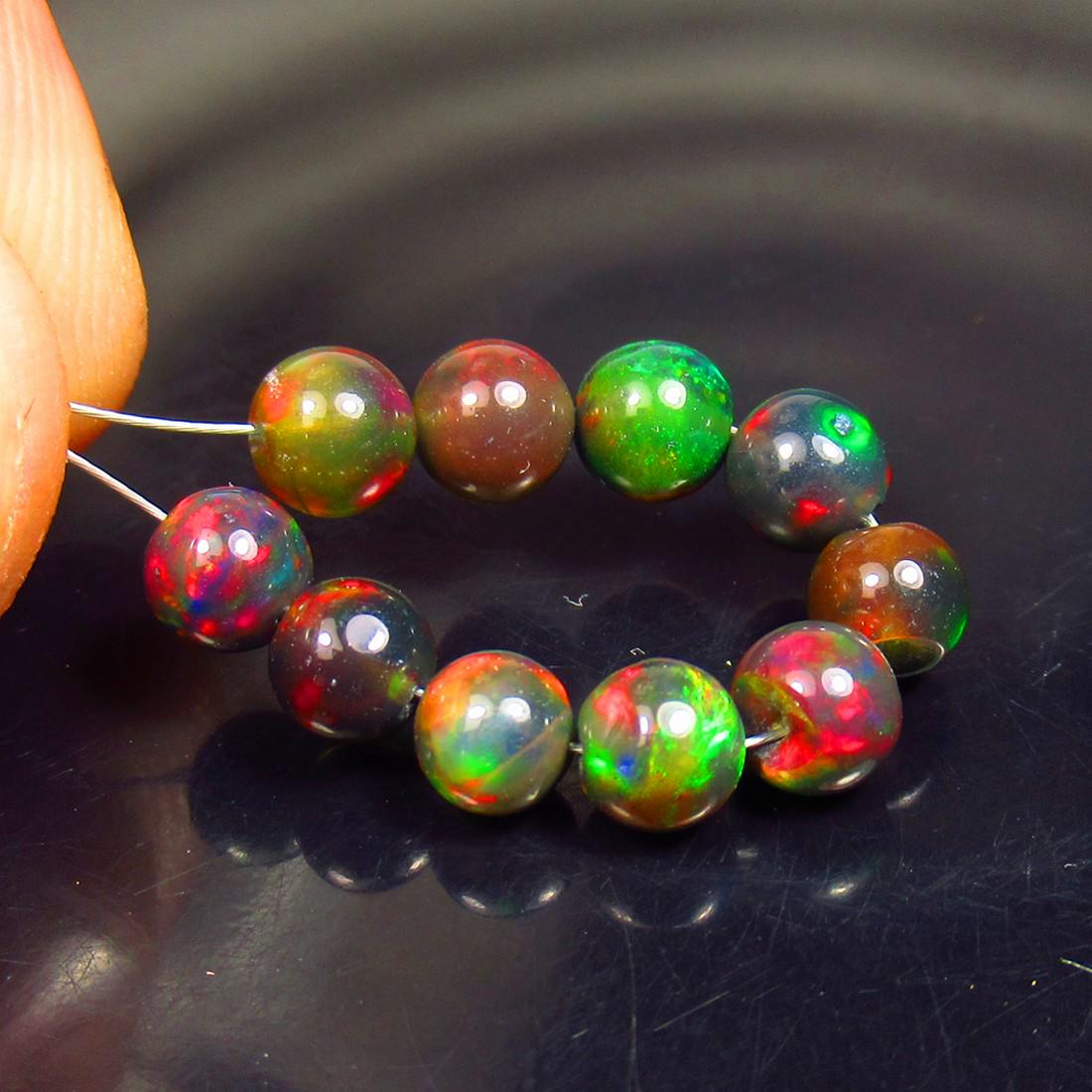 5.30 Ctw Natural 10 Drilled Black Fire Opal Ball Beads: No Reserve! Title: 5.30 Ctw Natural 10 Drilled Black Fire Opal Ball Beads Stone Clarity: Translucent Gemstone: Black Opal Beads Carat Weights: 5.30 Size/Dimensions: 4.70 to 5.10 mm / 10 PC's Additiona