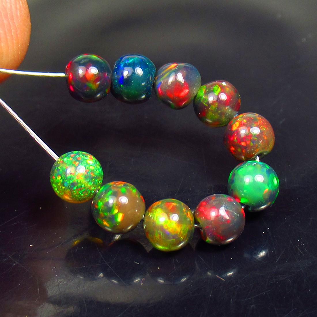 3.33 Ctw Natural 10 Drilled Black Fire Opal Ball Beads: No Reserve! Title: 3.33 Ctw Natural 10 Drilled Black Fire Opal Ball Beads Stone Clarity: Translucent Gemstone: Black Opal Beads Carat Weights: 3.33 Size/Dimensions: 4.00 to 4.30 mm / 10 PC's Additiona
