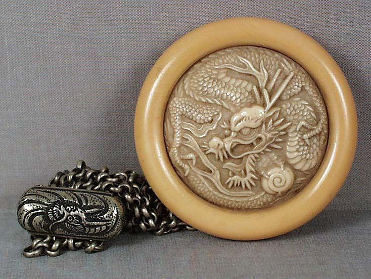 1920s kagamibuta netsuke DRAGON: 1920s kagamibuta (mirror lid) netsuke with plastic top and celluloid bowl imitating ivory. The top represents a dragon clutching Sacred Pearl in its paw. Excellent crisp work, overall in excellent con