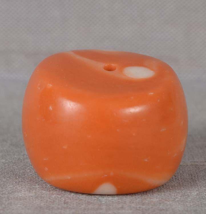 19c Tibetan RED CORAL BEAD 12.4 grams: 19th century good size Tibetan coral bead of squat cylinder shape. Natural red to salmon pink coral, beautiful growth texture seen on the terminal sides. Wonderful patina from wear, very pleasant to h