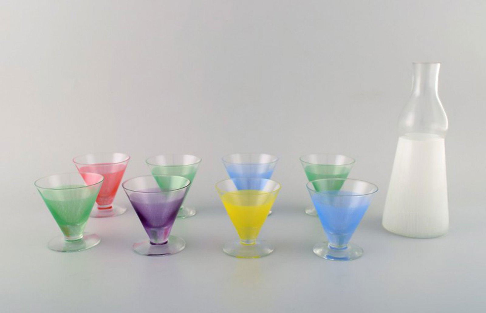 8 colorful cocktail glasses with decanter/bottle. "Party", Bengt Orup, Johansfors. Designed in 1953.: 8 colorful cocktail glasses with decanter/bottle. "Party", Bengt Orup, Johansfors. Designed in 1953. Swedish design. Glass measures 7.5 cm. x 7.5 cm. Decanter measures 21 cm x 8.5 cm. In perfect condi