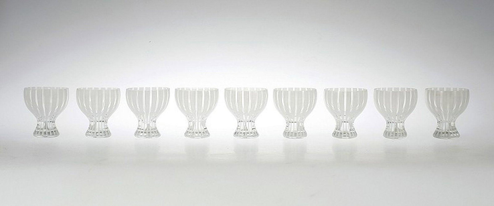 9 Cocktail Glass "Strict", Bengt Orup, Johansfors.: 9 Cocktail Glass "Strict", Bengt Orup, Johansfors. 1950s. White. Height 8 cm. In good condition, 2 glass with a crack. Reserve: $525.00 Shipping: Domestic: Shipping rates are determined by destination