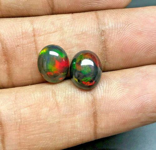 Pair of Natural Opal Black 0.60tcw Oval Multi Colours VVS: Title: Pair of Natural Opal Black 0.60tcw Oval Multi Colours VVS Additional Information: 1 x Pair of (2 Stones) Natural Opal Black 0.60tcw Oval Multi Colours Dancing VVS - Shape: Oval - Weight: 0.60tc