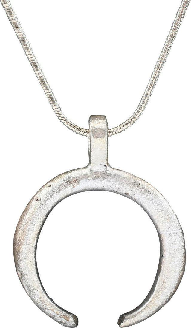 VIKING LUNAR PENDANT, C. 900-1000 AD: Just over 1" width. As expert navigators, the constellations signified mystery and power to Vikings. The Moon was personified as Mani, brother to Sol the Sun, and is abundantly represented in Norse li