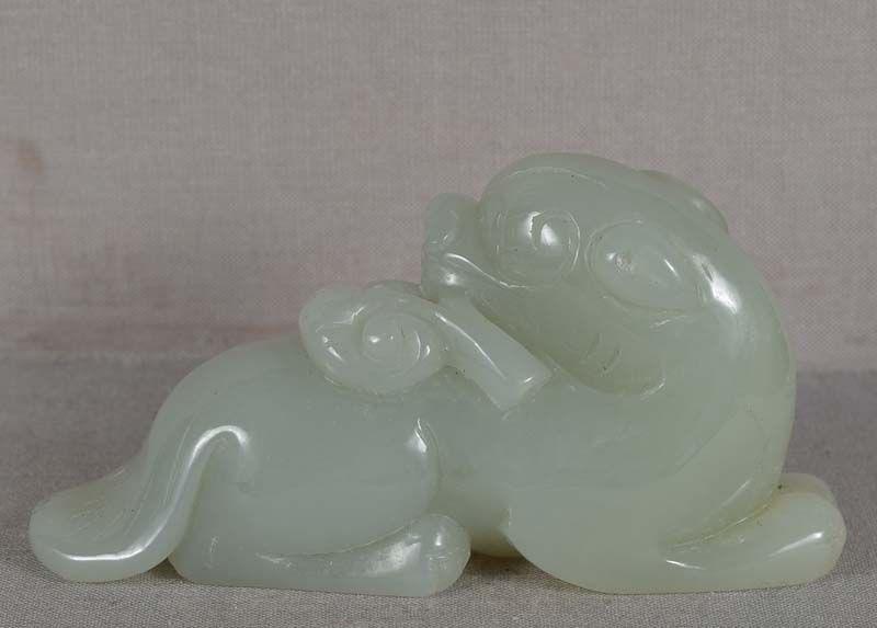 19c Chinese jade carving DOG with Fungus of Immortality: 1930s Chinese jade carving of a resting dog., its head turned back as it clenches the Fungus of Immortality in its mouth. Beautiful true nephrite jade of celadon color, wonderful carving, great face,