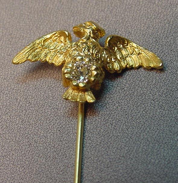 Superb Antique 18k Diamond Mythological Bird Stick Pin: Superb antique 18k gold diamond mythological bird stick pin centered with a beautiful H color VS-2 clarity diamond measuring 1/4 carat. The diamond is an antique old mine cushion cut. The bird's wings