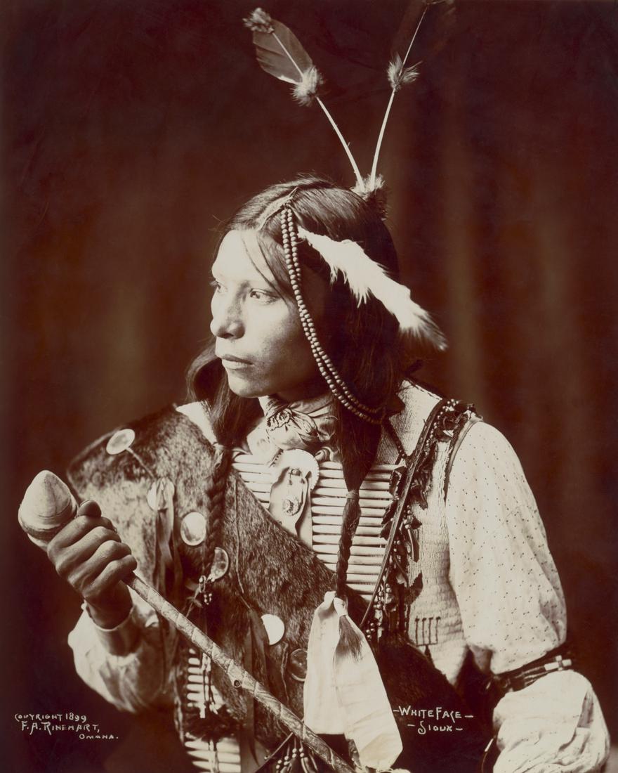 1899_WHITE FACE – SIOUX, HOLDING A LONG HANDLED WAR CLUB: Title: 1899_WHITE FACE – SIOUX, HOLDING A LONG HANDLED WAR CLUB Artist/Source: FRANK A. RINEHART W/ ASSISTANT ADOLPH MUHR. (FRANK RINEHART COPYRIGHT CLAIMANT) Medium: PHOTOLITHOGRAPH AFTER RINEH