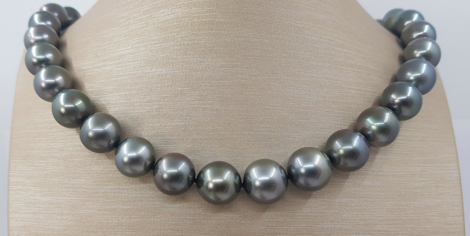 Large 11x13.7mm Round Peacock Tahitian Pearls - Necklace: Title: Large 11x13.7mm Round Peacock Tahitian Pearls - Necklace Description: A luxury pearl necklace, made with round Tahitian pearls, and completed with a solid invisible clasp. Tahitian pearls are c