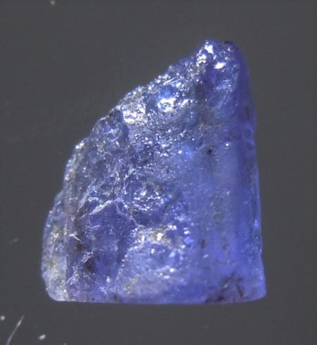 1.8 CT SKY BLUE TANZANITE - UNTREATED GEMSTONE: Title: 1.8 CT SKY BLUE TANZANITE - UNTREATED GEMSTONE Origin: Merelani, Arusha Dist. Tanzania Size: 0.85x0.7x0.4 cm / 0.38 gram Description: sky blue tanzanite with crystalline faces Reserve: $5.00 Sh