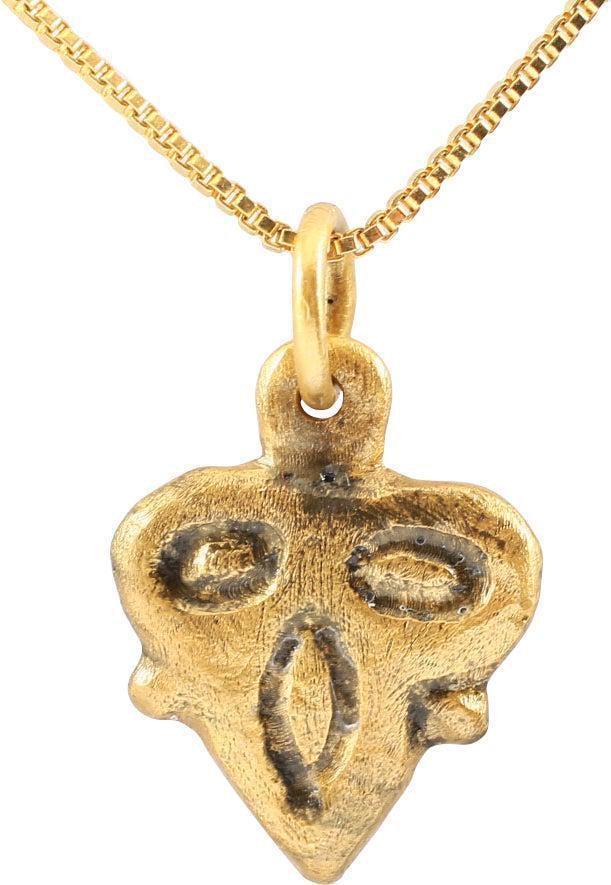 FINE VIKING HEART PENDANT, 9TH-10TH CENTURY AD: Gilt bronze. Under 3/4" height with raised edge defining the fully evolved cusped top heart. The field with a well-delineated foliate trefoil dividing it into three segments with nubs at the midpoint.