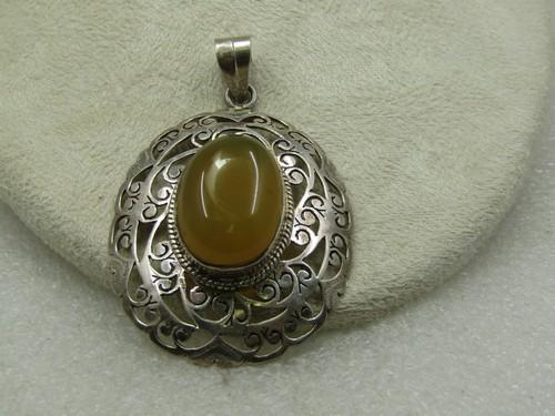 Vintage Sterling Yellow Carnelian Filigree Pendant, 2.5": Vintage Sterling Yellow Carnelian Filigree Pendant, 2.5" by 1-1/8". Raised bezel-set yellow carnelian that is appx. 25mm by 18mm with a wider rope accent around the bezel. The design of the pendant is