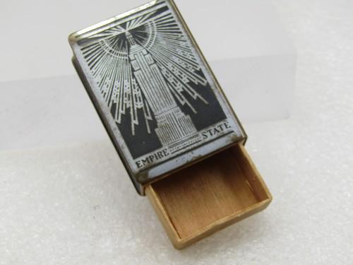 Vintage 1930's Empire State Building Matchbox Souvenir, Art Deco: Vintage 1930's Empire State Building Matchbox Souvenir Silver and black. The emptire Statement building with reflecting rays on the front and Empire State World's Tallest Building on back. This has th