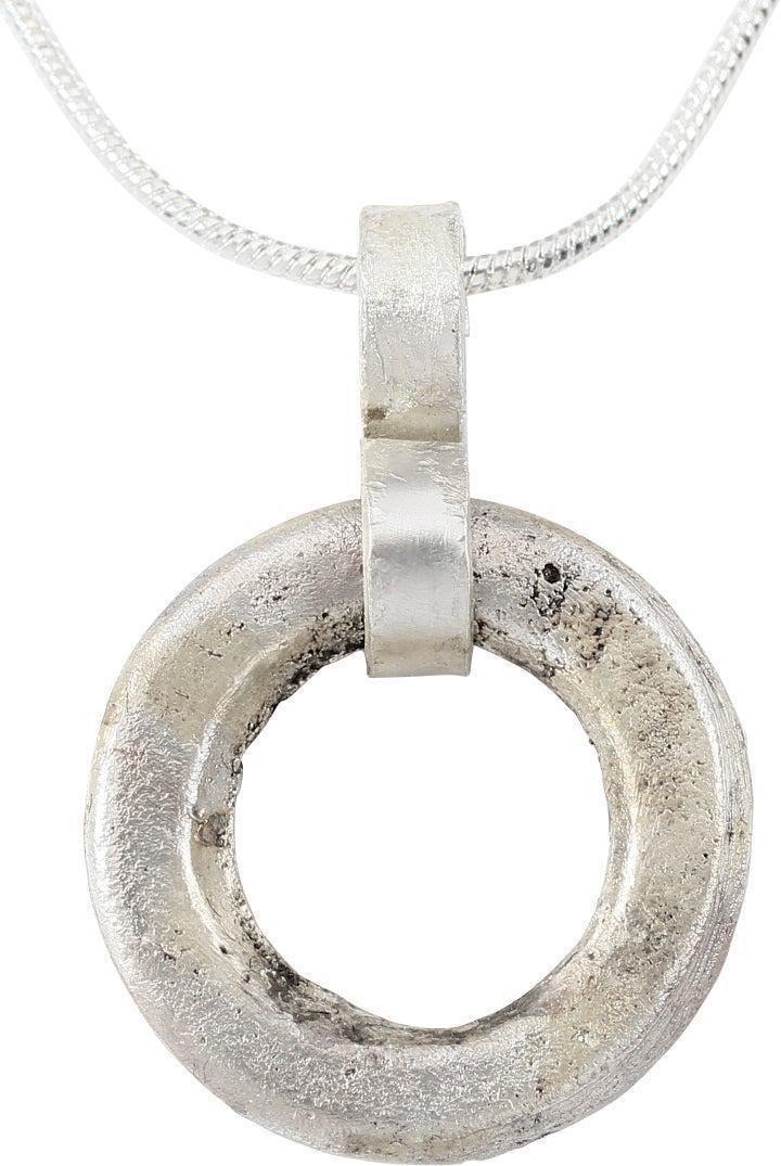 VIKING PROTECTIVE ARMOR BROOCH NECKLACE, 10TH CENTURY: Silvered bronze, about 3/4" diameter. Circular with both sides flattened ad the outer edge partially flattened for rounded rectangular section. Professionally refurbished with the silver overlay resto