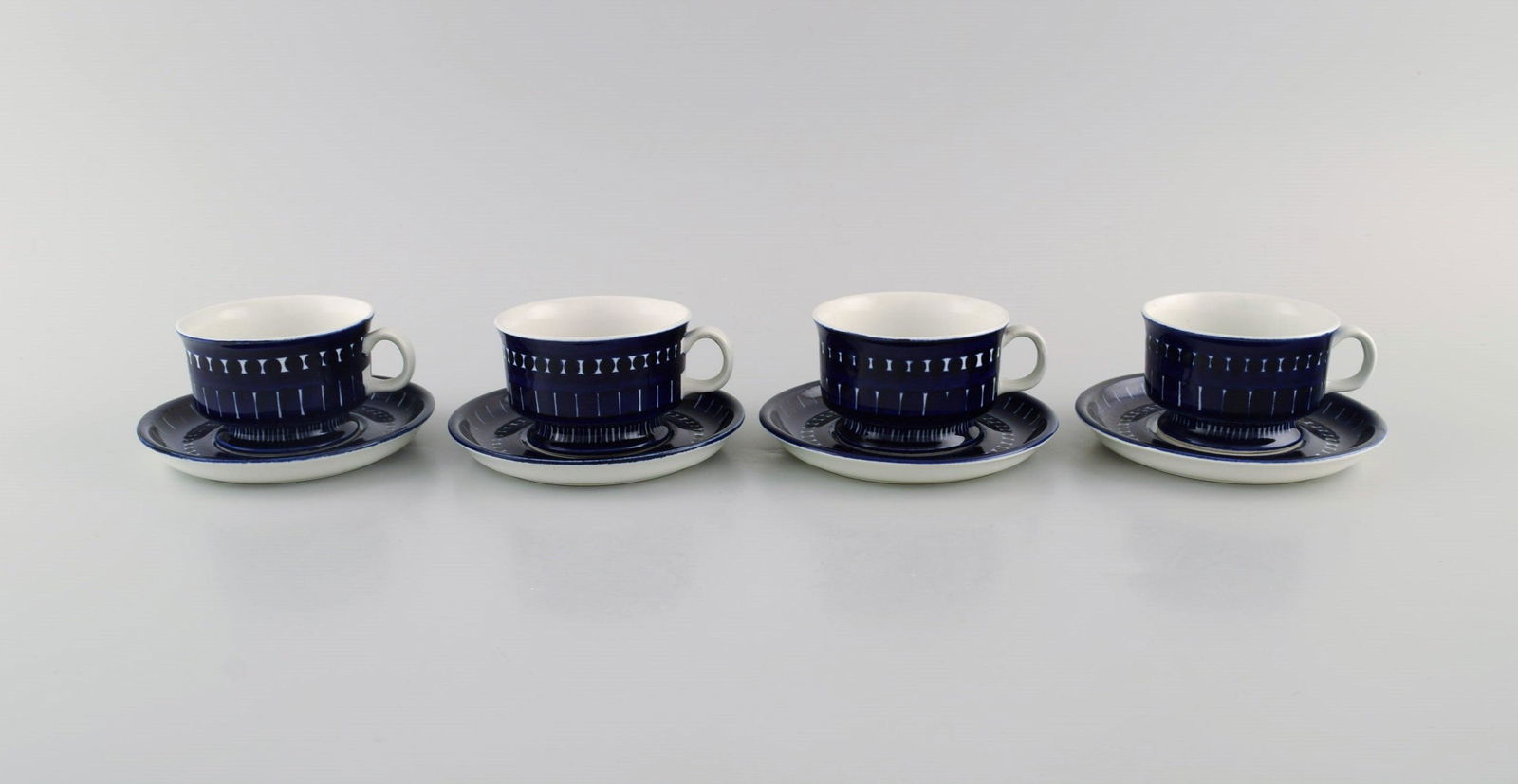 Ulla Procope for Arabia. Four Valencia teacups with saucers in hand-painted porcelain. 1960s.: Ulla Procope for Arabia. Four Valencia teacups with saucers in hand-painted porcelain. 1960s. The cup measures: 7.5 x 4.8 cm. Saucer diameter: 11.5 cm. In excellent condition. Signed. Reserve: $350.00