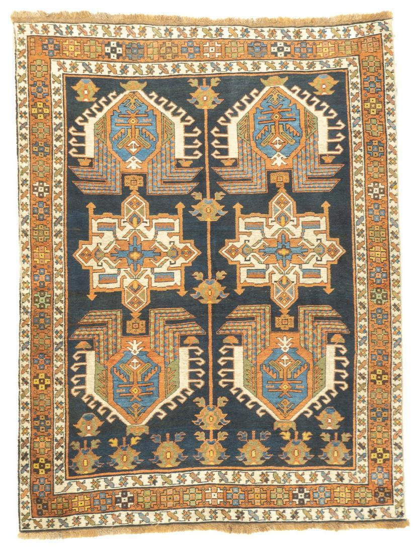Antique Bakhshayesh Rug, 4'11'' x 6'5'' (1.50 x 2.00 m): East Caucasian village scatter with the characteristic Perpedil design of rams’ horns, daggers, octagons and birds, on a navy ground. Red, rust and green details. Navy main border of ecru knots and