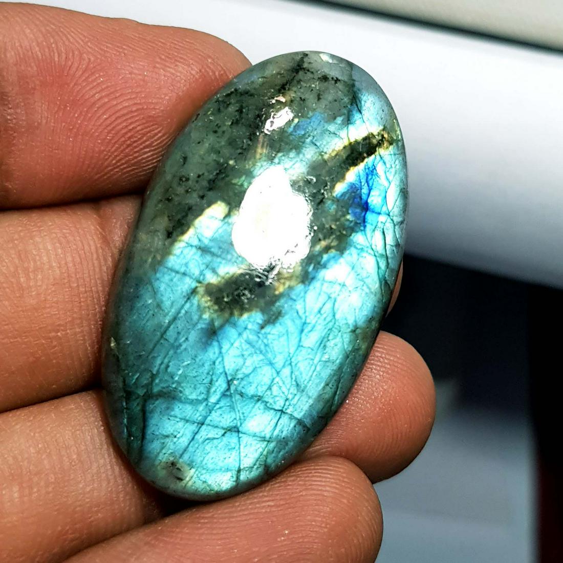 50.11 Ctz Natural Labradorite: No Reserve! Title: 50.11 Ctz Natural Labradorite Color/Clarity: Bluish Green / Semi Transparent Gemstones: Labradorite Carat Weights: 50.11 Size/Dimensions: 39.25 x 22.35 x 6.60 Additional Information