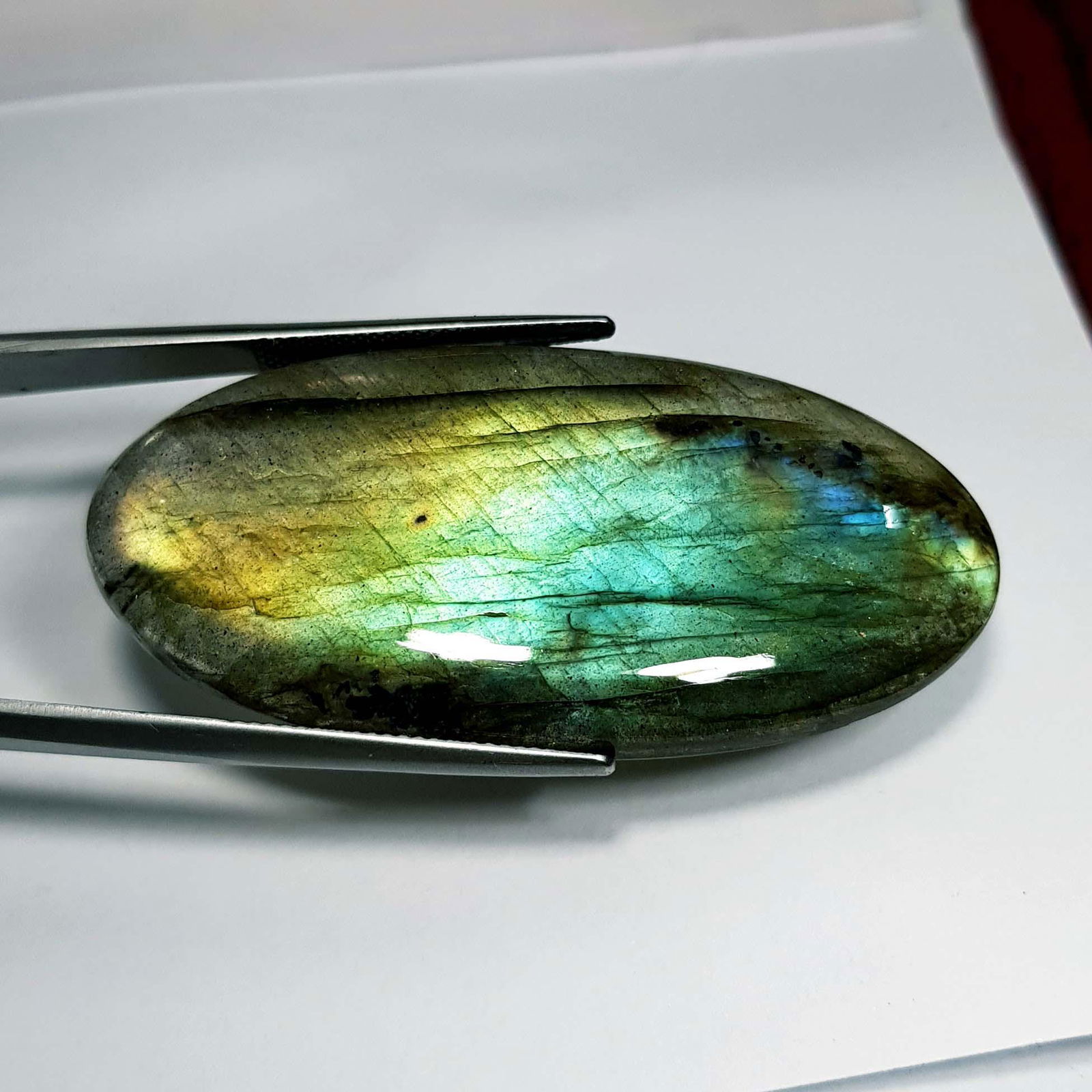 66.82 Ctz Natural Labradorite: No Reserve! Title: 66.82 Ctz Natural Labradorite Color/Clarity: Bluish Green / Semi Transparent Gemstones: Labradorite Carat Weights: 66.82 Size/Dimensions: 53.90 x 25.60 x 5.70 Additional Information
