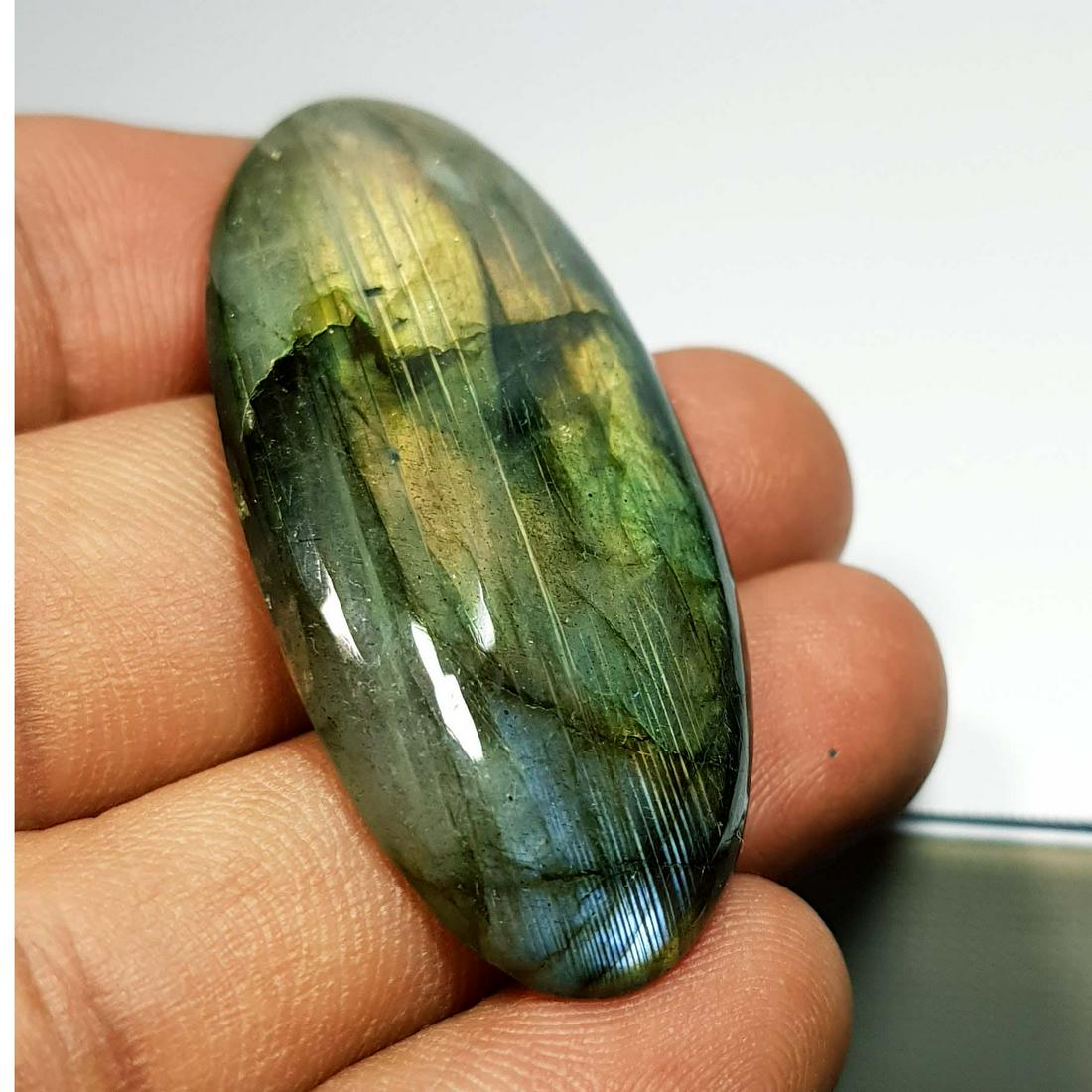 52.75 Ctz Natural Labradorite: No Reserve! Title: 52.75 Ctz Natural Labradorite Color/Clarity: Bluish Green / Semi Transparent Gemstones: Labradorite Carat Weights: 52.75 Size/Dimensions: 46.10 x 22.45 x 6.10 Additional Information