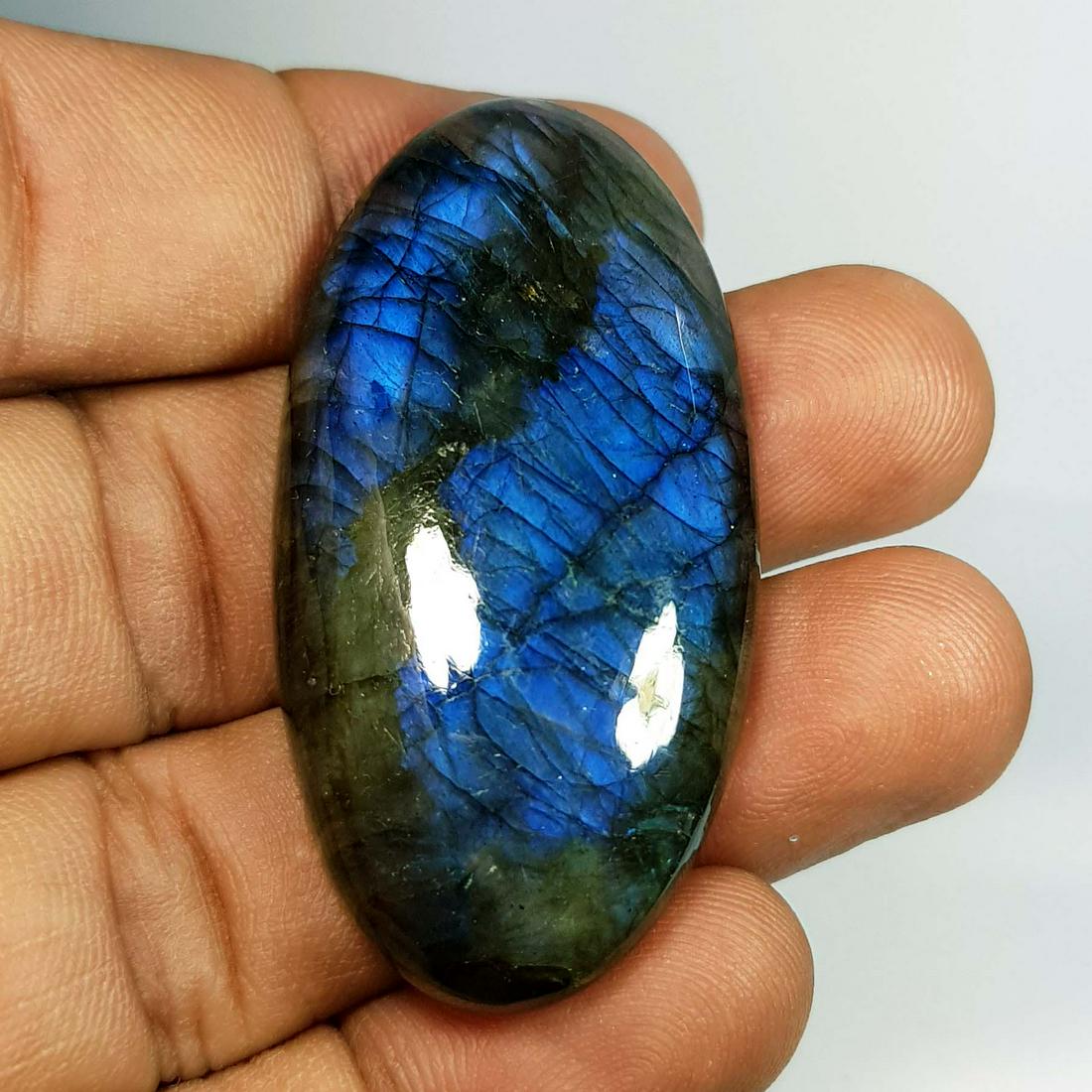79.05 Ctz Natural Labradorite: No Reserve! Title: 79.05 Ctz Natural Labradorite Color/Clarity: Bluish Green / Semi Transparent Gemstones: Labradorite Carat Weights: 79.05 Size/Dimensions: 48.15 x 24.75 x 7.90 Additional Information
