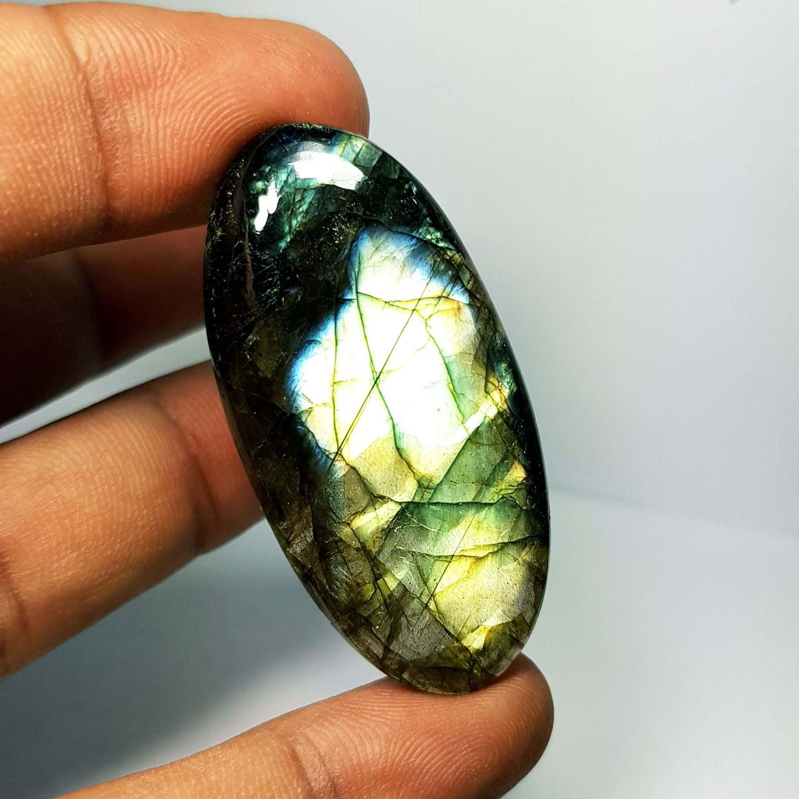 56.98 Ctz Natural Labradorite: No Reserve! Title: 56.98 Ctz Natural Labradorite Color/Clarity: Bluish Green / Semi Transparent Gemstones: Labradorite Carat Weights: 56.98 Size/Dimensions: 46.65 x 22.95 x 6.00 Additional Information