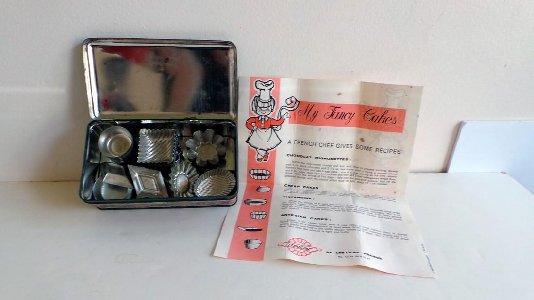43 Petit Four Cake Tins/molds by Matfer (variety of shapes): 43 Petit Four Cake Tins/molds by Matfer (variety of shapes) - c. 19601800’s - Condition: in original tin with original recipe box in both French and English - Size: 5 cm across Shipping: Domesti