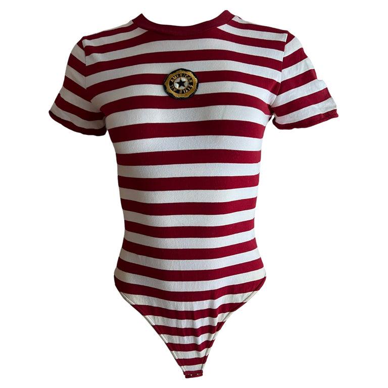 DKNY Red & White Cotton Striped T-shirt Bodysuit, Size Small: - Crew neckline - Short sleeves - Striped pattern - Features star motif & “AMERICA STYLES ALL” embroidery on the front Designer Donna Karan Dimensions Length: 29.5 in. (74.93 cm)Marked Siz
