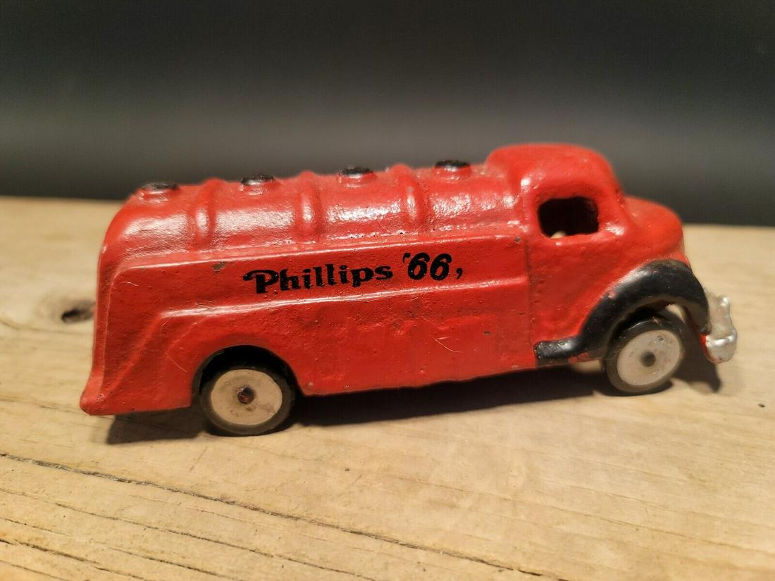 Red Cast Iron Toy Phillips 66 Car Delivery Van: 6" Long x 2 3/8" Wide 2 1/4" Tall 1 lbs 5 oz Such a neat reproduction cast iron car! As you can see this heavy cast iron car was wonderfully hand painted and distressed to look original. The car is mo