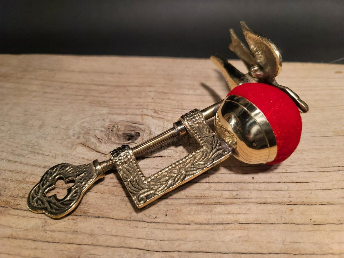 Brass Eagle Sewing Clamp Pin Cushion: 6 1/8" Tall x 4" Clamp opens to 1" Well made functional reproduction brass sewing clamp/pin cushion. Such a neat cast brass eagle clamp on the top. Reserve: $20.00 Shipping: Domestic: Flat-rate of $7.