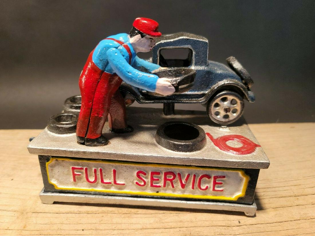 Cast Iron Full Service Automotive Mechanical Coin Bank: 7" long x 3 1/2" Wide Great reproduction Americana folk art cast iron mechanical coin bank. This piece was made to look just like an antique, but is actually new. By pressing the lever on the back the